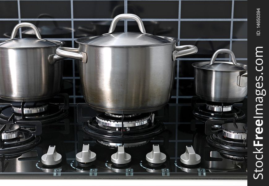 A stainless steel pot on a cook top. A stainless steel pot on a cook top