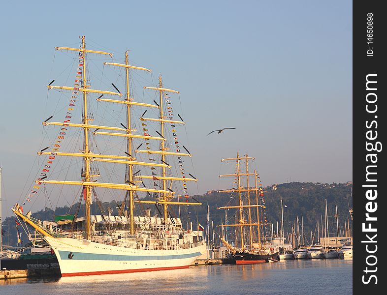 Tall sailing ships docking in a port