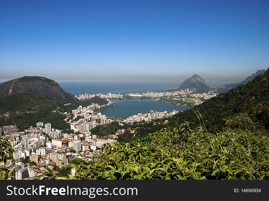 An aerial shot of rio de janeiro and the green around the city.Lagoa Rodrigo de Freitas, mostly known as Lagoa, is a lagoon and district in the Lagoa, Zona Sul (South Zone) of Rio de Janeiro. The lagoon is connected to the Atlantic, allowing sea water to enter, by a canal which is bordered by the park locally known as Jardim de Alá. An aerial shot of rio de janeiro and the green around the city.Lagoa Rodrigo de Freitas, mostly known as Lagoa, is a lagoon and district in the Lagoa, Zona Sul (South Zone) of Rio de Janeiro. The lagoon is connected to the Atlantic, allowing sea water to enter, by a canal which is bordered by the park locally known as Jardim de Alá.