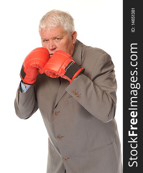 Successful mature business man on white background, boxing with red gloves. Successful mature business man on white background, boxing with red gloves
