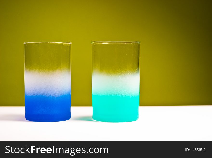Glass vessels standing on the white table, isolated background