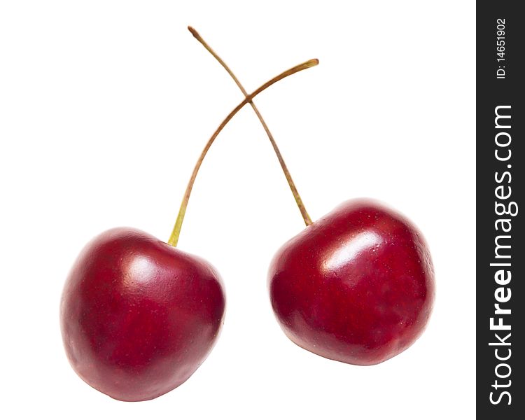 Two sweet ripe cherries are isolated on the white. Two sweet ripe cherries are isolated on the white