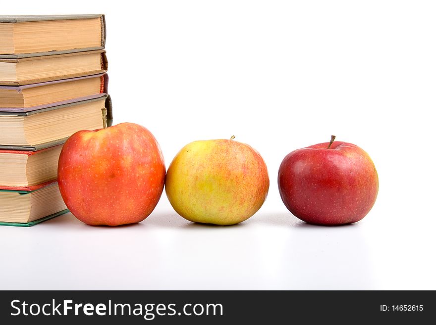 Apples and books isolated on a white background