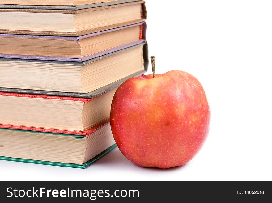 Apple and books isolated on a white background