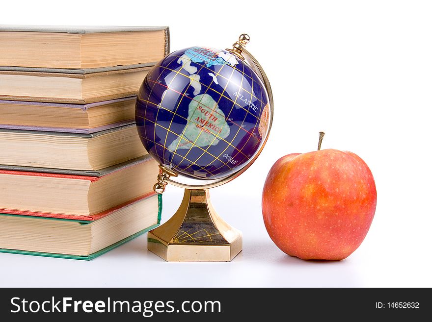Apple, globe and books isolated on a white background