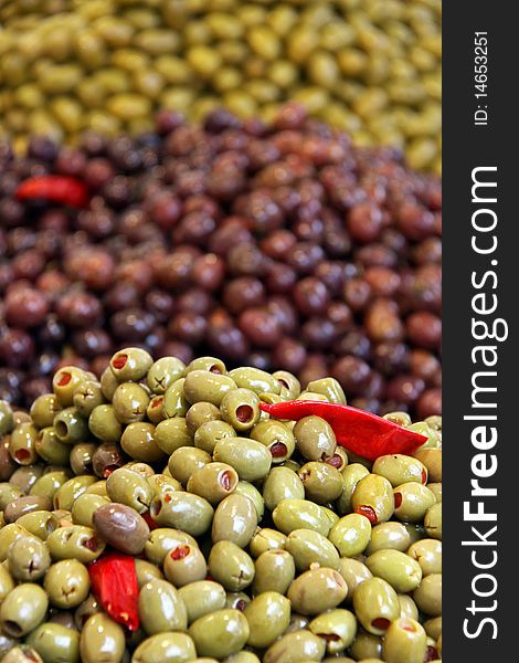 Green and black olives and sun dried tomatoes at a food market