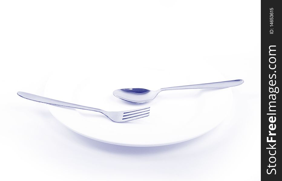 Empty plate with spoons on white. Empty plate with spoons on white