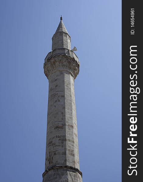 Bosnian minaret, towering over mostar's blue sky