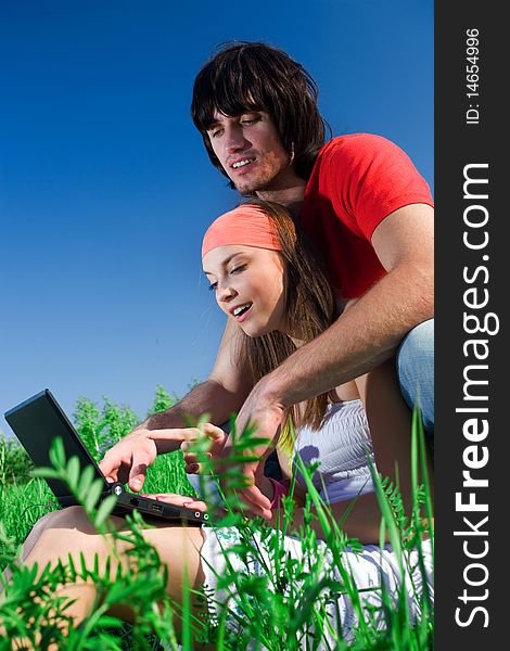 Boy and beautiful girl with notebook on grass. Boy and beautiful girl with notebook on grass