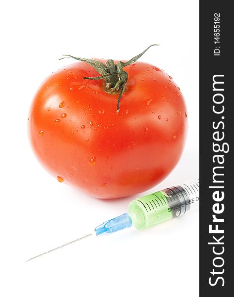 Tomato with syringe over white