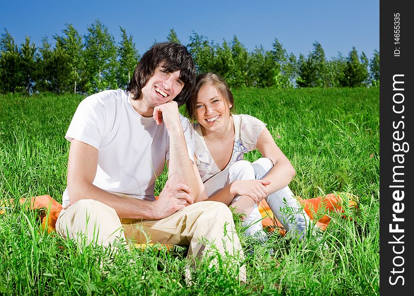 Beautiful girl and boy on grass