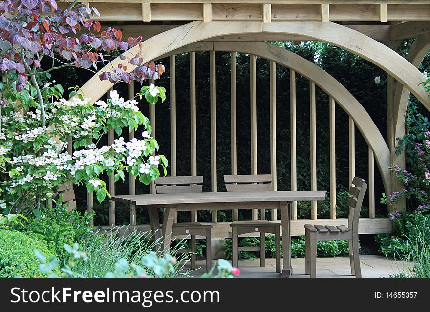 Garden table and chairs under wooden structure. Garden table and chairs under wooden structure
