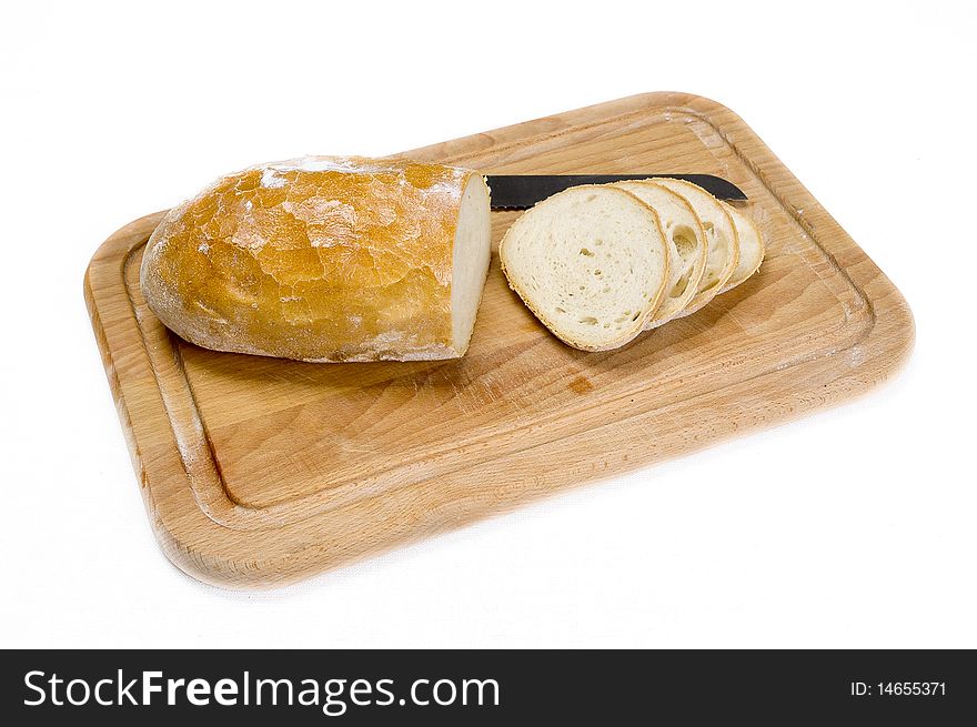 Partially sliced bread on a wooden board