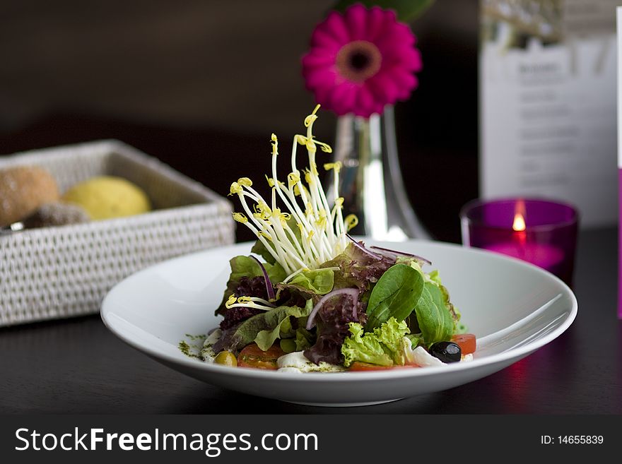 Healthy salad with lettuce, tomato, mozzarella and onions.