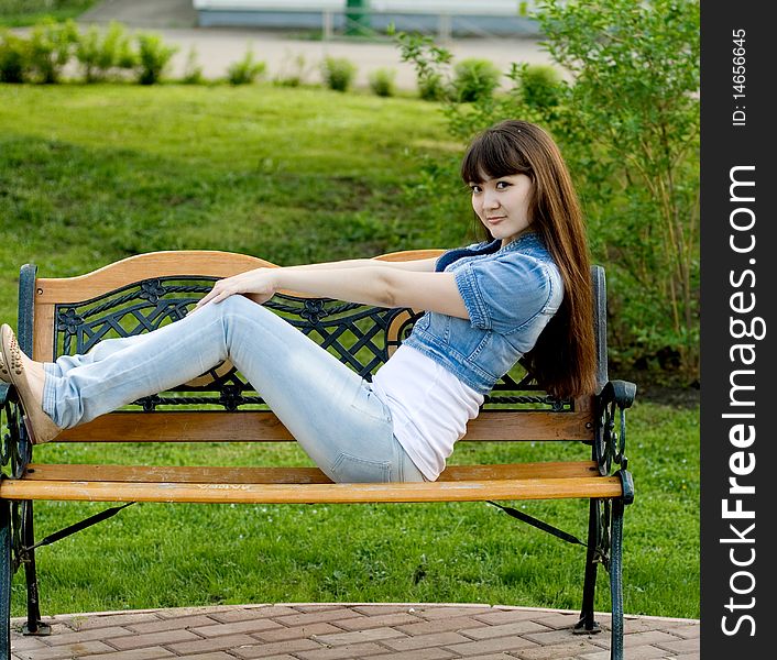 Girl lying on bench outdoor