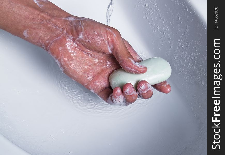 Man hand holding soap under water. Man hand holding soap under water