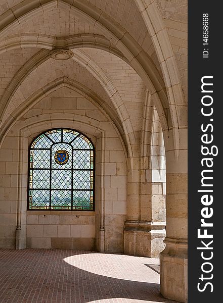 An old paned window beneath an arched and vaulted ceiling in an old french castle. An old paned window beneath an arched and vaulted ceiling in an old french castle.