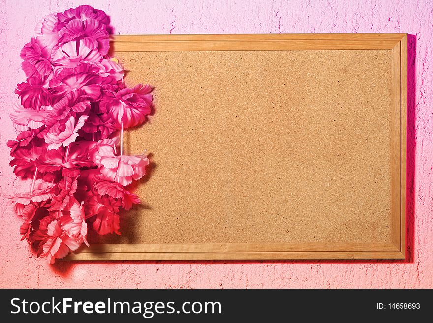 Floral frame of wood with fake plastic flowers