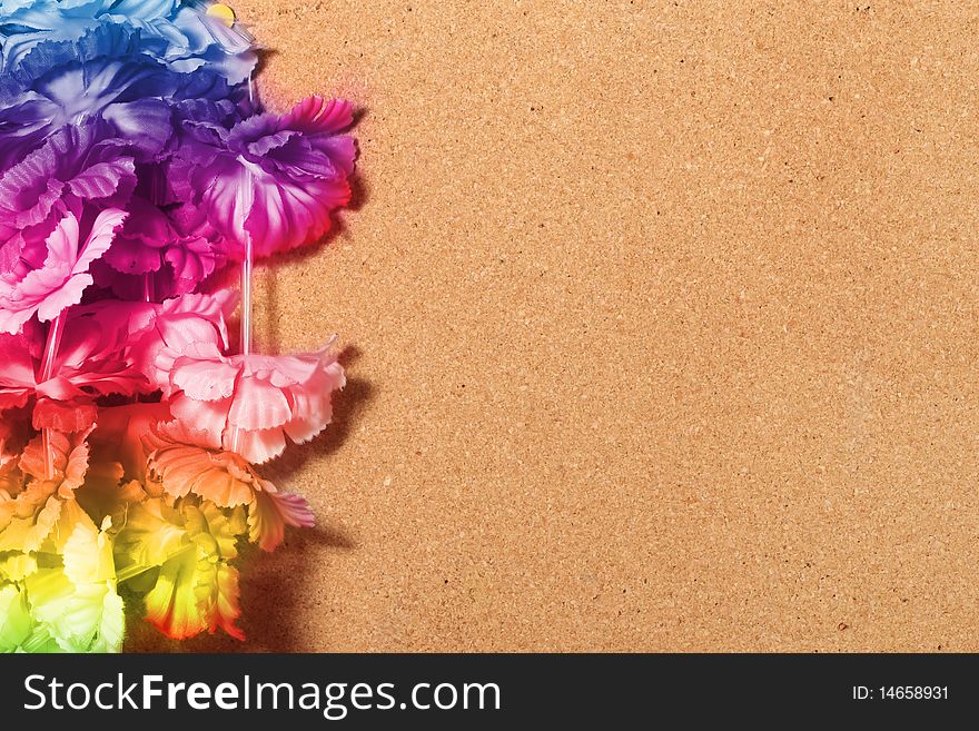 Floral frame of wood with fake plastic flowers