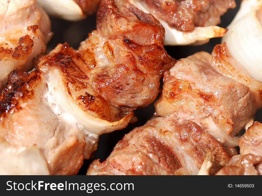 Juicy slices of meat with sauce prepare on fire. Juicy slices of meat with sauce prepare on fire