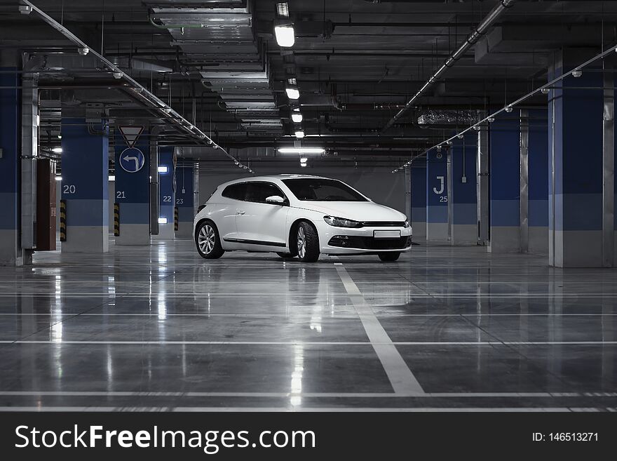 Exterior of white modern sport car at parking at evening time