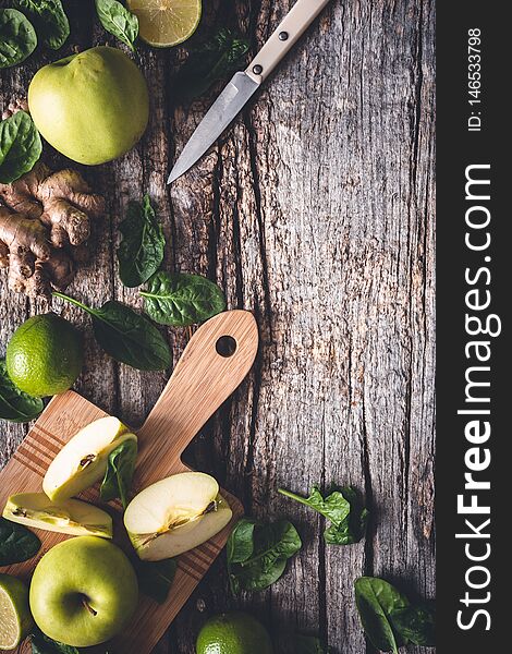 Ingredients for Green Smoothie with Spinach, Apple, Lime and Ginger. Healthy Drink on wooden background