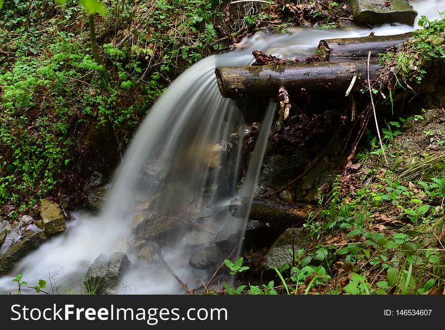 Beautiful waterfall with clear water on a mountain stream in the forest after rain