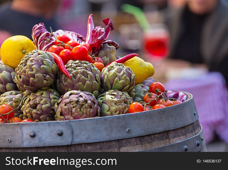 Fresh artichokes and tomatoes at farmers market