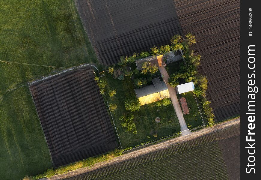 Aerial shot of an Abandoned Ranch in spring sunset in cultivated agricultural fields, Vojvodina landscape. Aerial shot of an Abandoned Ranch in spring sunset in cultivated agricultural fields, Vojvodina landscape