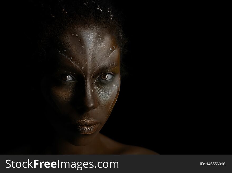 Portrait of beautiful African girl with traditional tribal paintings on her face on black background. Portrait of beautiful African girl with traditional tribal paintings on her face on black background