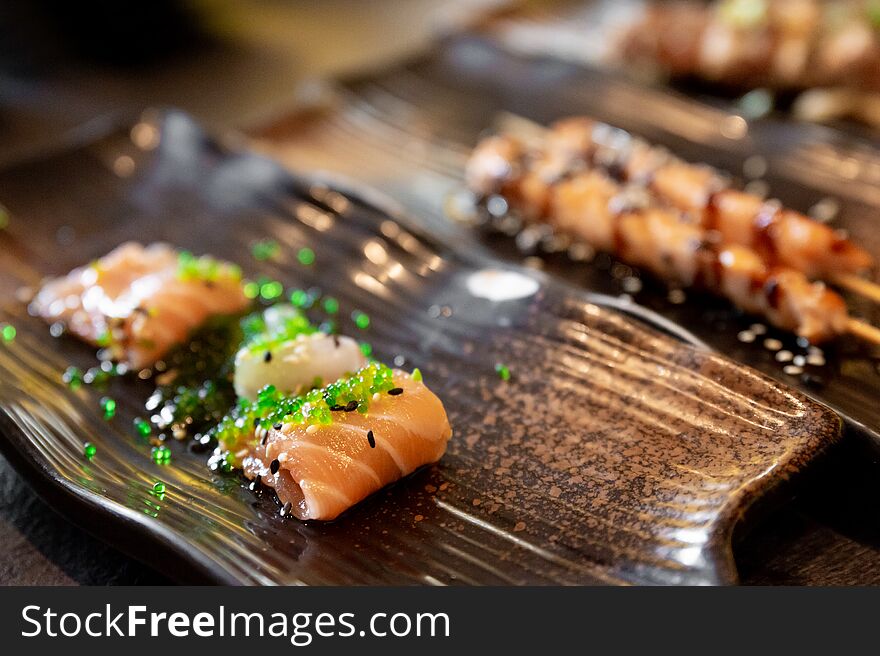 Salmon and sea bream sushi and tuna skewers of typical Japanese cuisine. Salmon and sea bream sushi and tuna skewers of typical Japanese cuisine