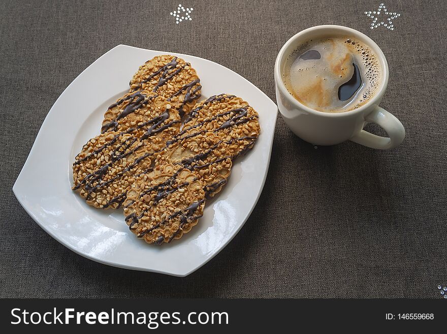 Coffee in cup whith cookies in the plate on dark background. Coffee in cup whith cookies in the plate on dark background