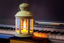 The Lantern With A Candle Illuminates The Keys To The Piano. Music In An Intimate Setting_ Royalty Free Stock Images