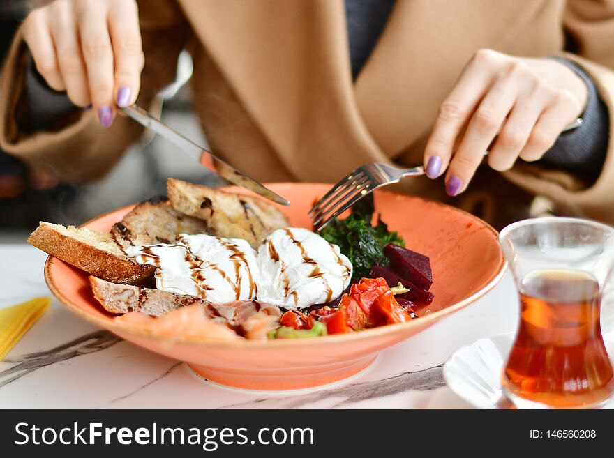 Girl eating healthy food in colorful plate
