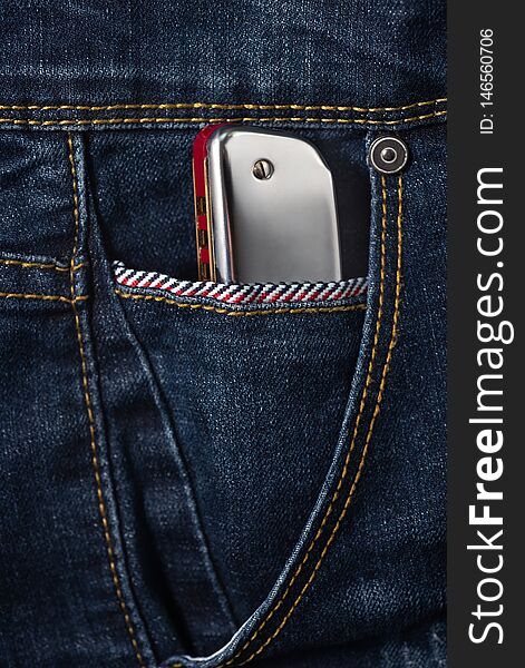 Blues harmonica in the jean pocket