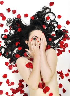 Woman With Falling Rose Petals Stock Photo