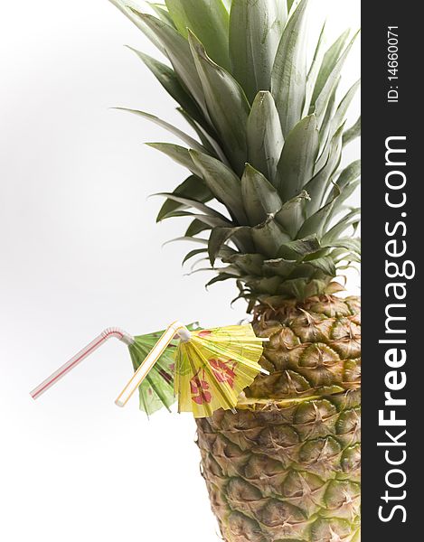 Pineapple with two straws and umbrellas isolated