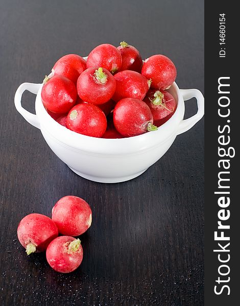 Fresh radishes in a white bowl