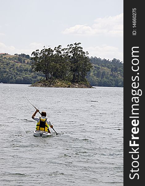 Man enjoying a morning in a dam kayaking. Man enjoying a morning in a dam kayaking