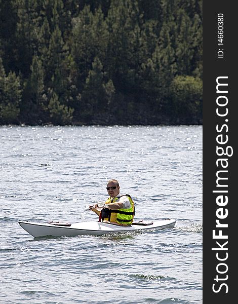 Man enjoying a morning in a dam kayaking. Man enjoying a morning in a dam kayaking