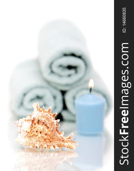 Seashell and candle with spa towels