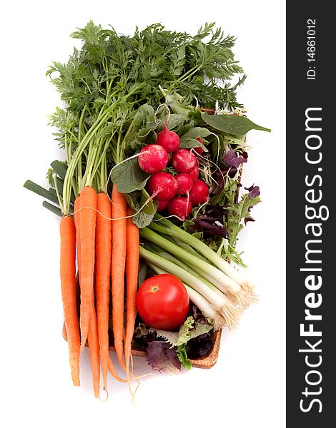 Fresh carrots, radishes, scallions, tomatoes and greens. Fresh carrots, radishes, scallions, tomatoes and greens