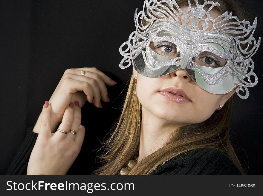 The beautiful woman with a mask in the face of