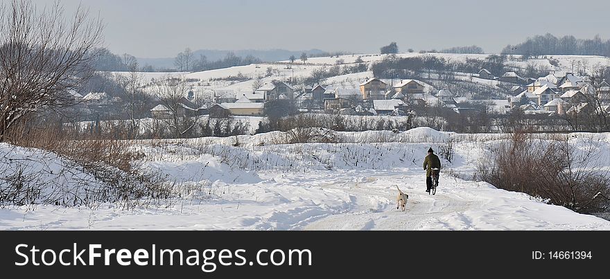 Winter landscape whith a men and a dog