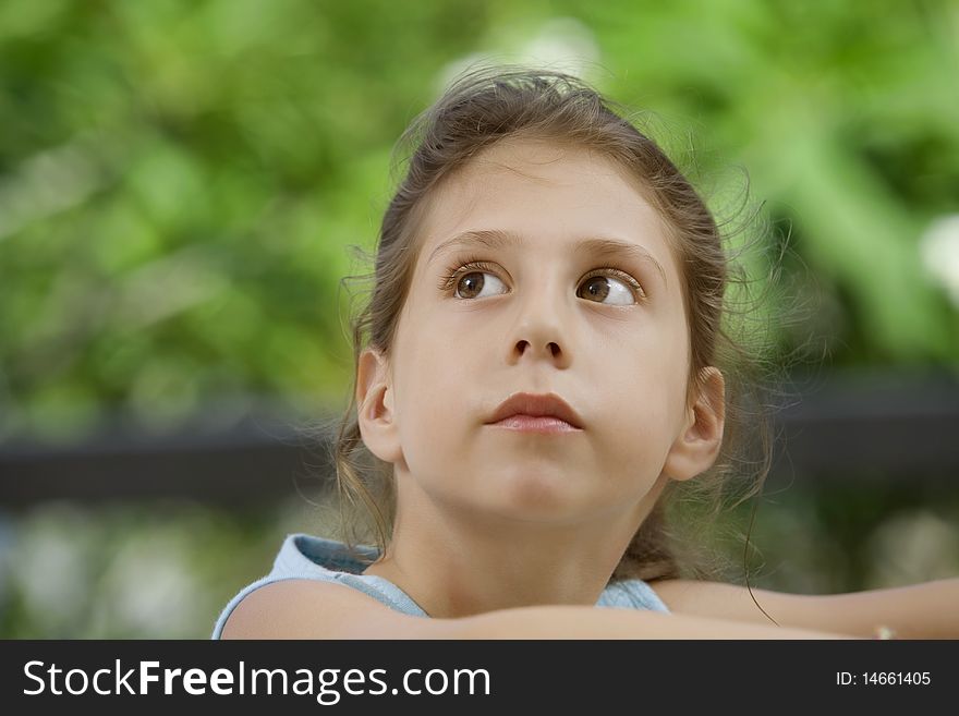 Portrait of nice little girl in summer environment