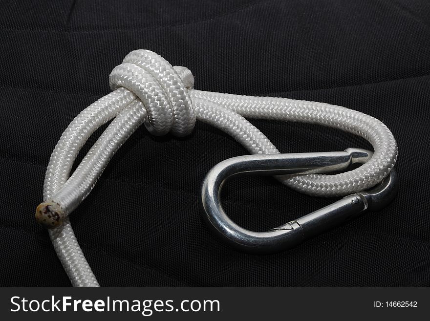 Rope noose with a carbine on a black background.