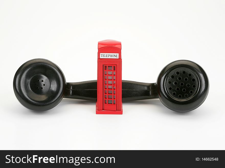 Old-fashioned black telephone receiver on white background