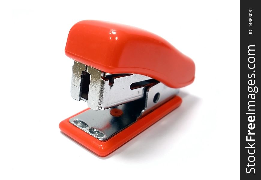 Small red stapler on the white backgraund