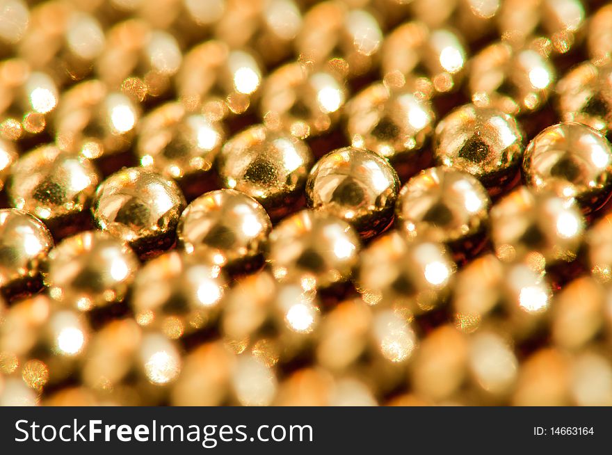 Shiny golden beads abstract background. selective focus. Shiny golden beads abstract background. selective focus.