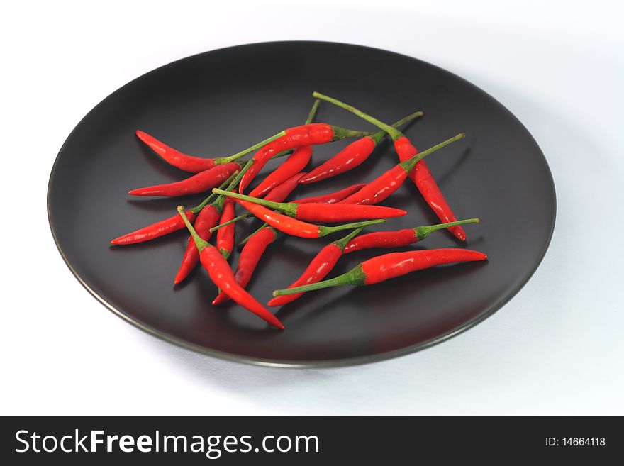 Red Hot Chilli Peppers are placed on black plate